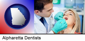 a dentist examining teeth in Alpharetta, GA
