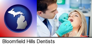 a dentist examining teeth in Bloomfield Hills, MI