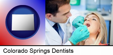 a dentist examining teeth in Colorado Springs, CO