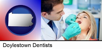 a dentist examining teeth in Doylestown, PA