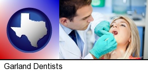 a dentist examining teeth in Garland, TX