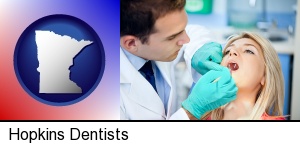 a dentist examining teeth in Hopkins, MN