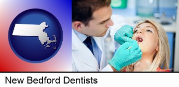 a dentist examining teeth in New Bedford, MA