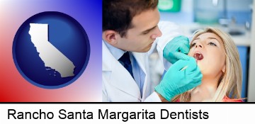 a dentist examining teeth in Rancho Santa Margarita, CA