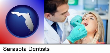 a dentist examining teeth in Sarasota, FL