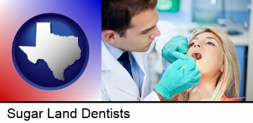 a dentist examining teeth in Sugar Land, TX