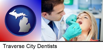 a dentist examining teeth in Traverse City, MI