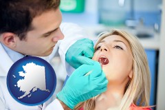 alaska map icon and a dentist examining teeth