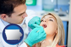 a dentist examining teeth - with Iowa icon