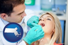 a dentist examining teeth - with Massachusetts icon