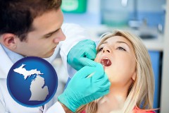 michigan map icon and a dentist examining teeth