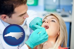 a dentist examining teeth - with North Carolina icon