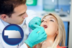 nebraska map icon and a dentist examining teeth