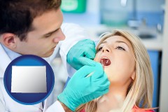 a dentist examining teeth - with WY icon