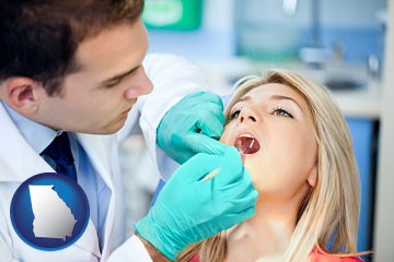 a dentist examining teeth - with Georgia icon