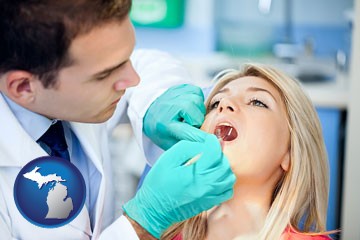 a dentist examining teeth - with Michigan icon
