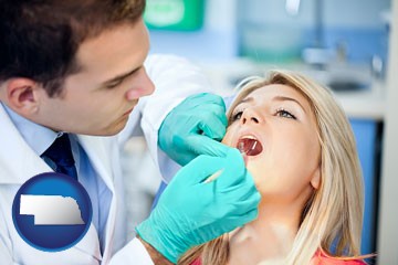 a dentist examining teeth - with Nebraska icon