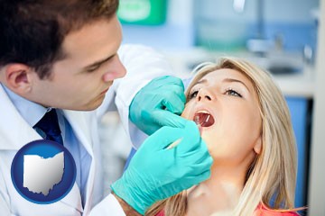 a dentist examining teeth - with Ohio icon