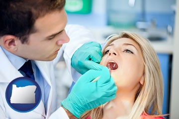 a dentist examining teeth - with Oregon icon