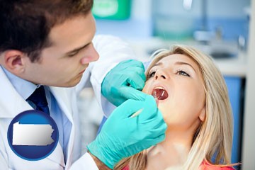 a dentist examining teeth - with Pennsylvania icon