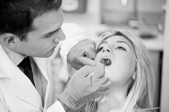 a dentist examining teeth
