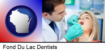 a dentist examining teeth in Fond Du Lac, WI