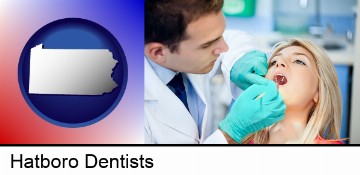 a dentist examining teeth in Hatboro, PA