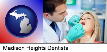 a dentist examining teeth in Madison Heights, MI