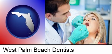 a dentist examining teeth in West Palm Beach, FL