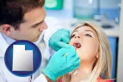 a dentist examining teeth - with UT icon